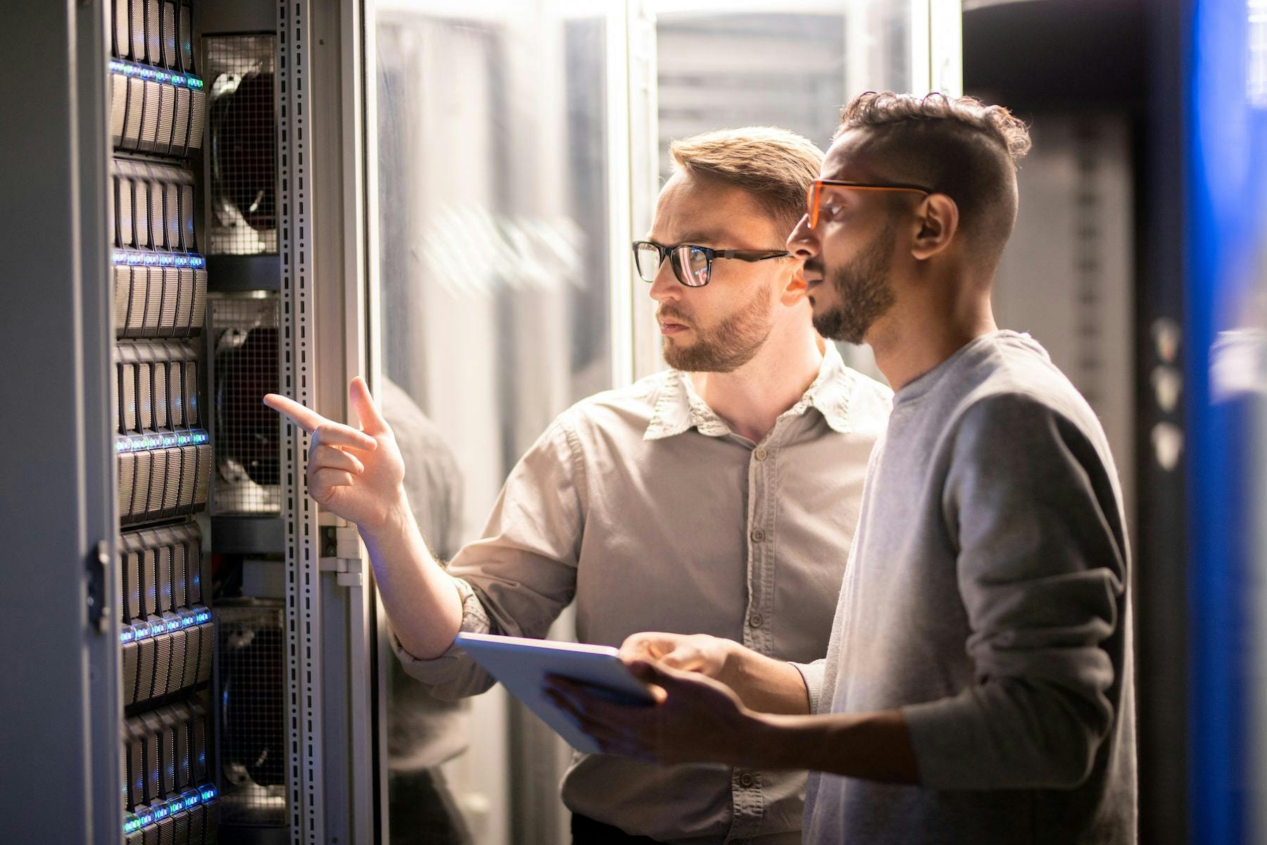 two guys inspecting data center for flaws and maintenance